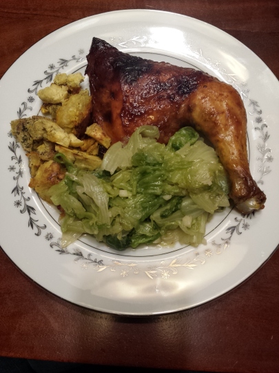 Glazed chicken leg served with sauteed lettuce and fried plantain